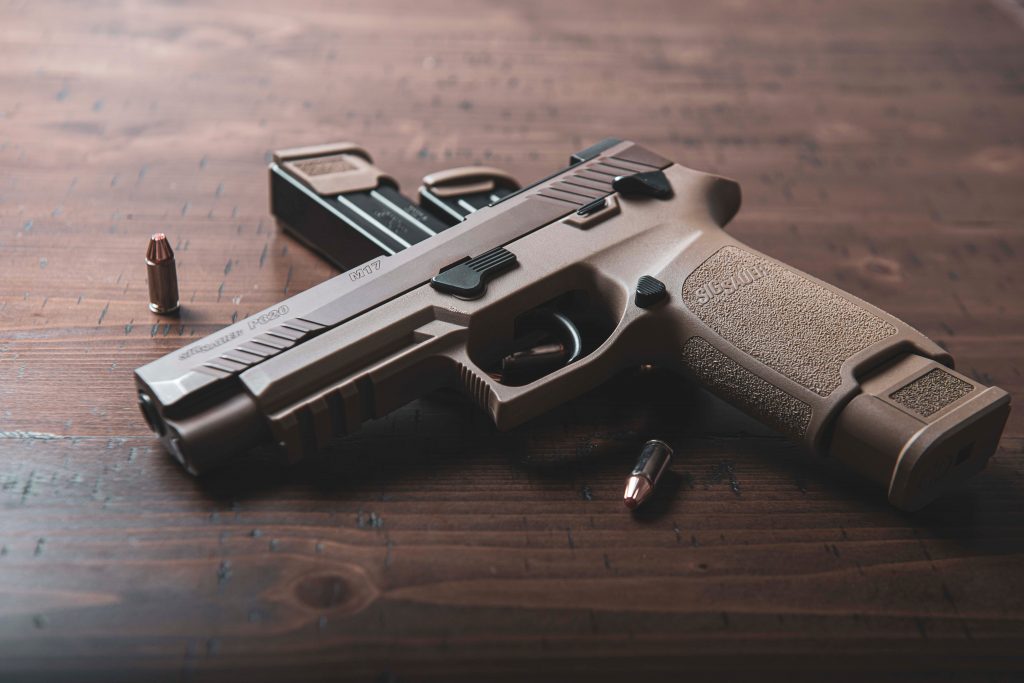 black-and-silver-semi-automatic-pistol-on-brown-wooden-table-3602944-1024x683